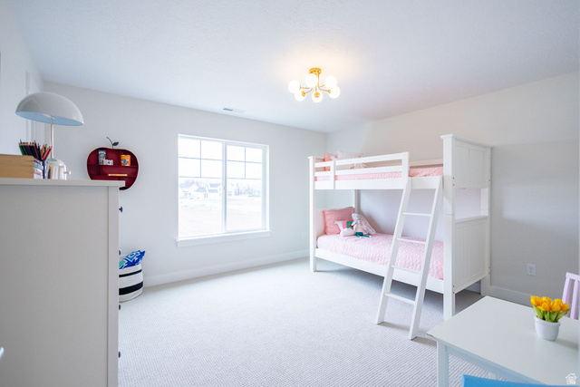 209 North 1140 West Mapleton, UT 84664 - Photo 18 of 21 Bedroom featuring light carpet and hanging lights