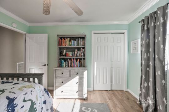 1113 Amie Court Ridgecrest, CA 93555 - Photo 20 of 33 a bedroom with furniture and a book shelf