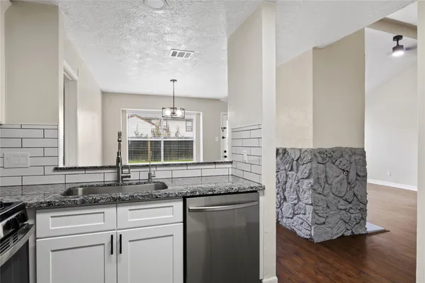 a kitchen with stainless steel appliances granite countertop a sink and a granite counter tops