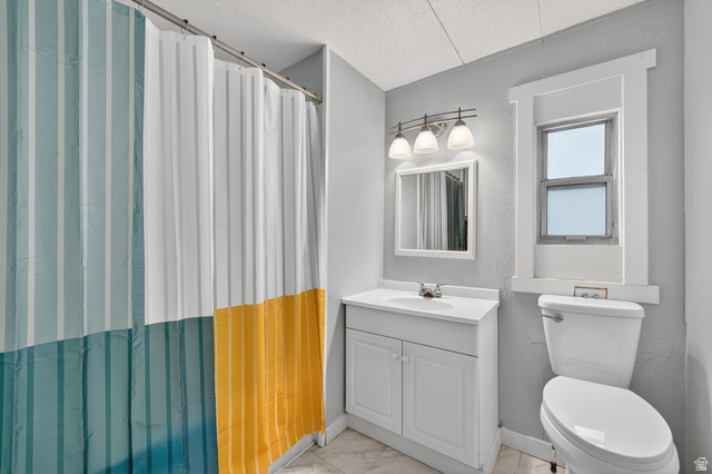 200 North Harrisville Road, Unit 37 Ogden, UT 84404 - Photo 6 of 14 Full bathroom with vanity, a shower with curtain, a textured ceiling, and light marble finish flooring