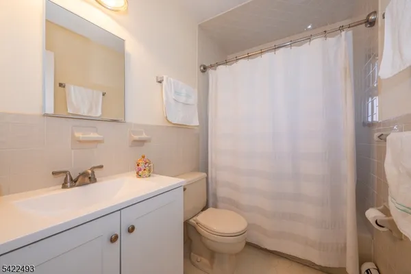 a bathroom with a sink mirror and a shower