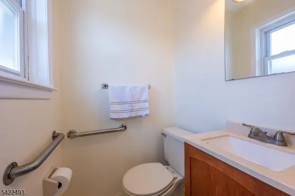 a bathroom with a sink a toilet and a mirror
