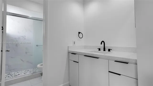 a white toilet sitting next to a shower