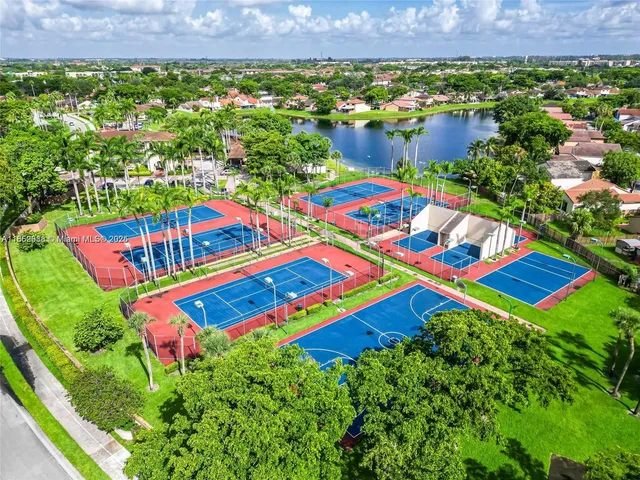 an aerial view of multiple houses with yard