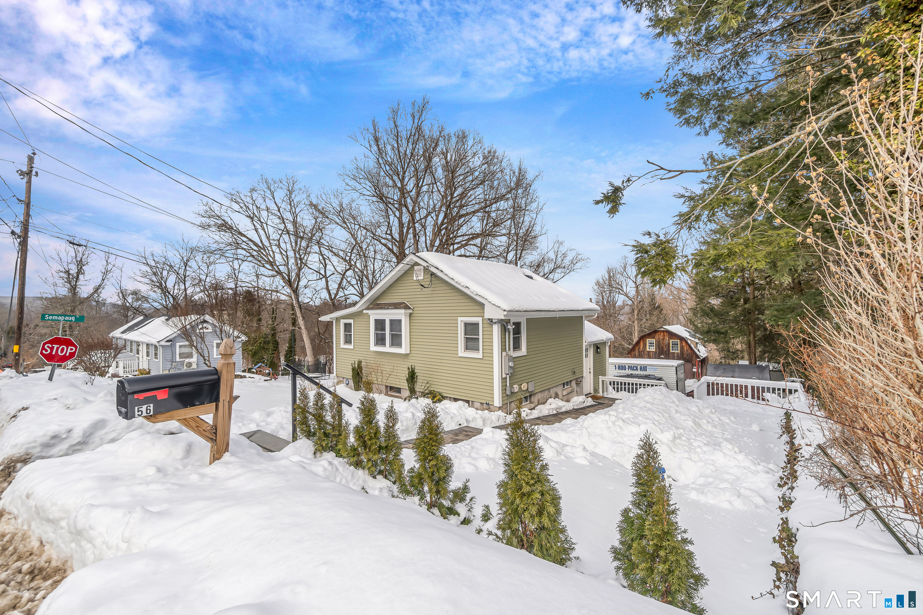 a view of a house with a yard covered in snow