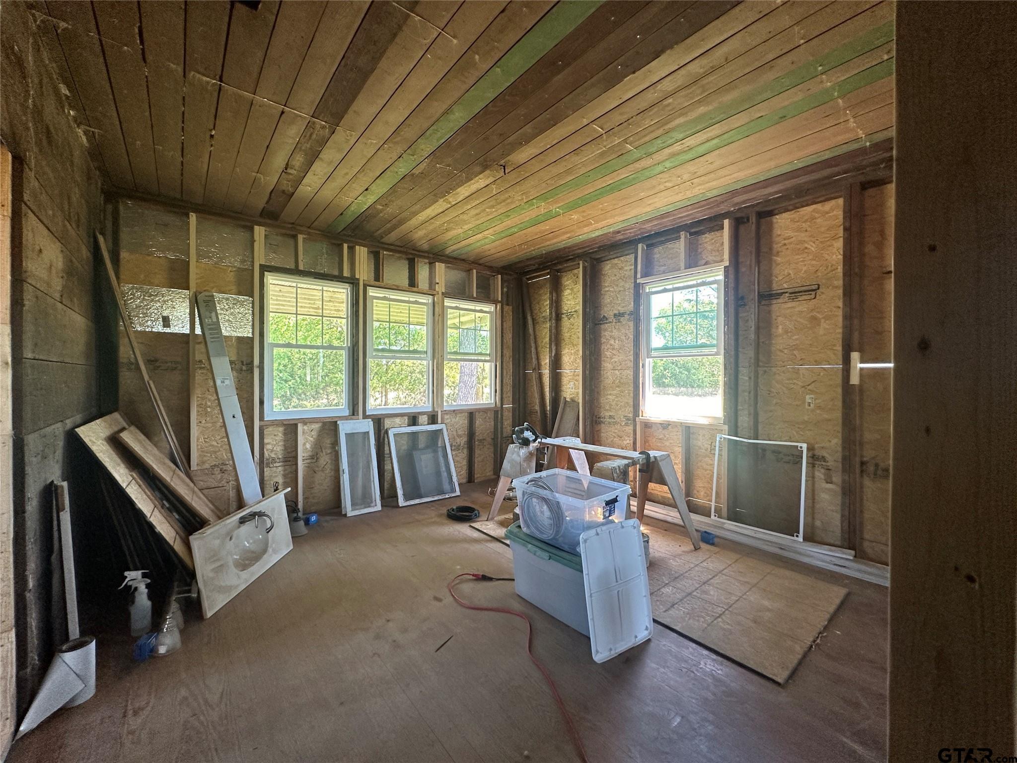 528 County Road 1830 Yantis, TX 75497 - Photo 12 of 13 a living room with furniture and a floor to ceiling window