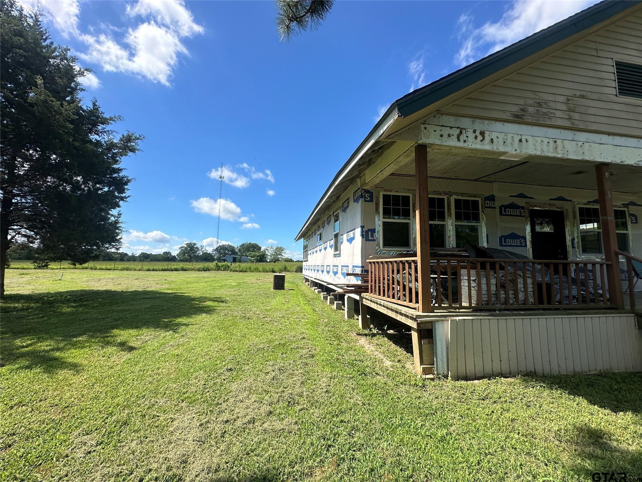 528 County Road 1830 Yantis, TX 75497 - Photo 4 of 13 a view of a house with wooden floor and a yard
