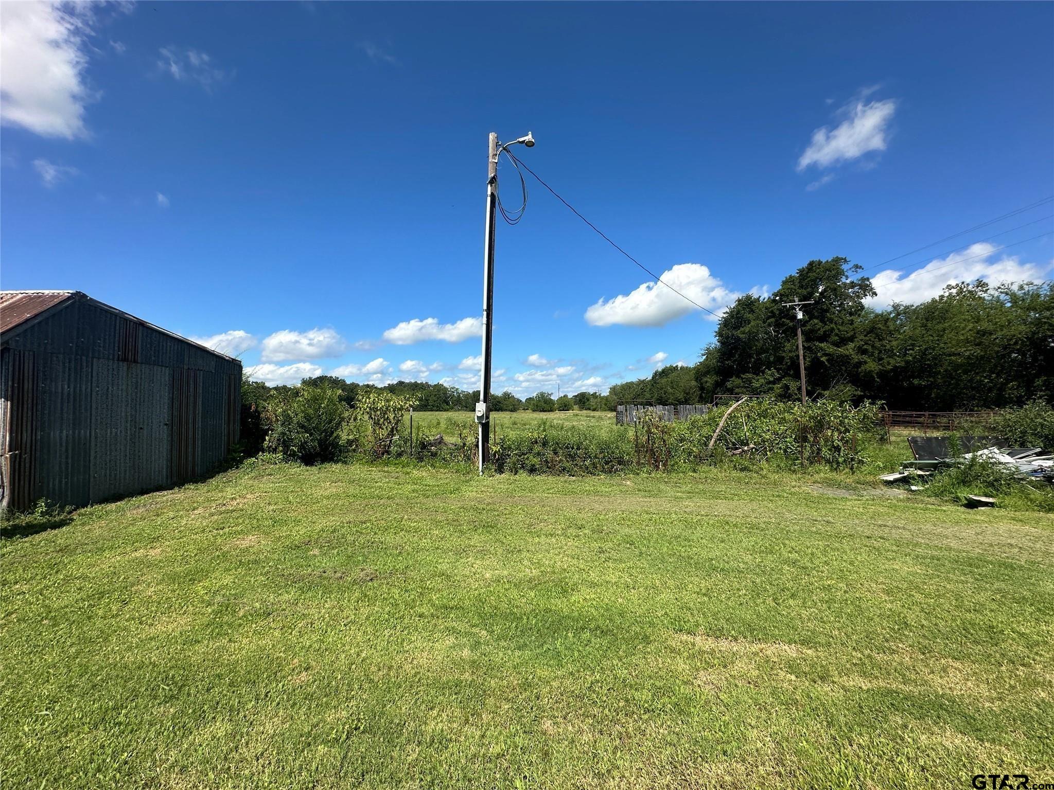 528 County Road 1830 Yantis, TX 75497 - Photo 7 of 13 a view of a yard and entertaining space
