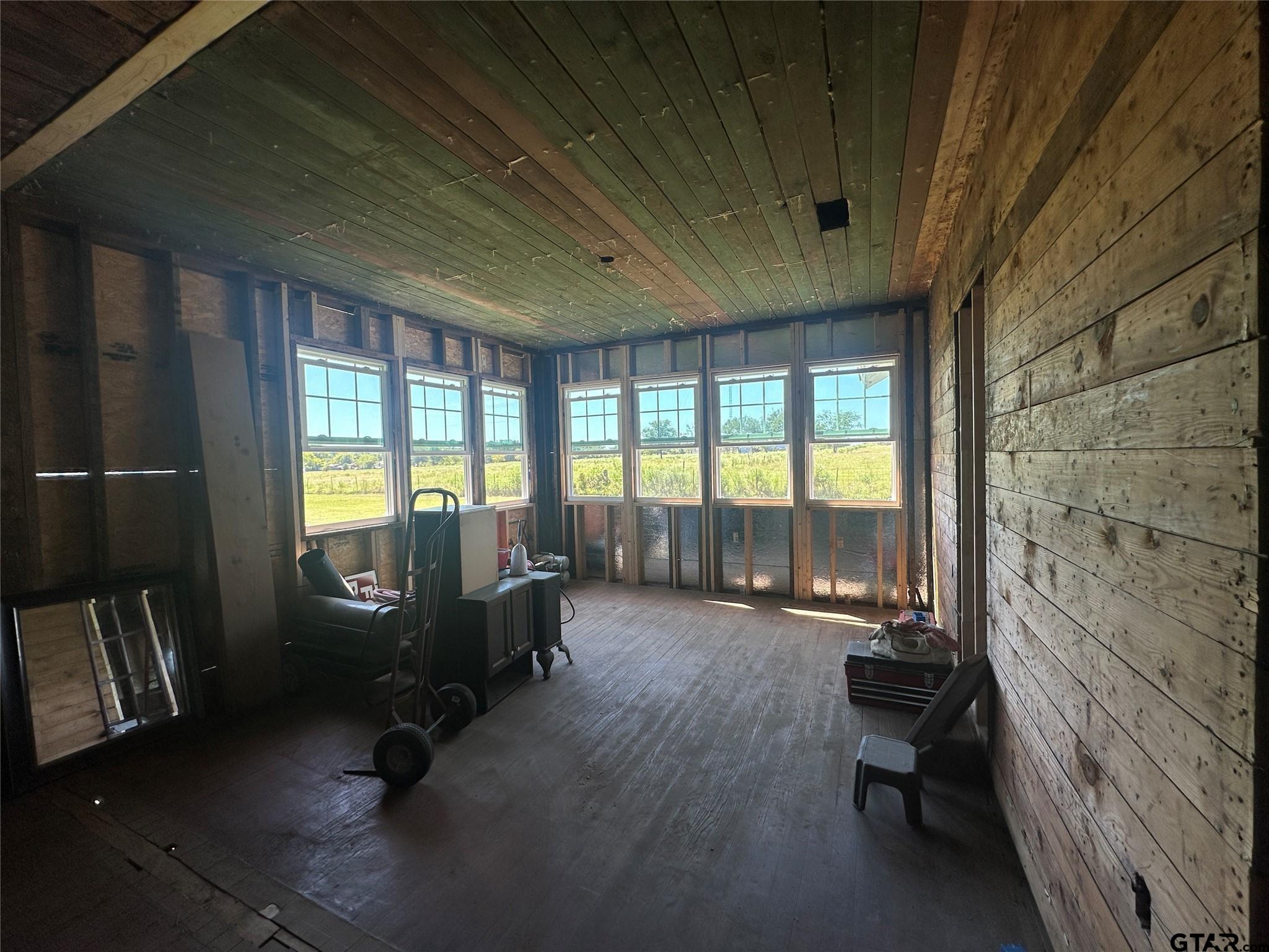 528 County Road 1830 Yantis, TX 75497 - Photo 9 of 13 a living room with furniture floor to ceiling window and wooden floor