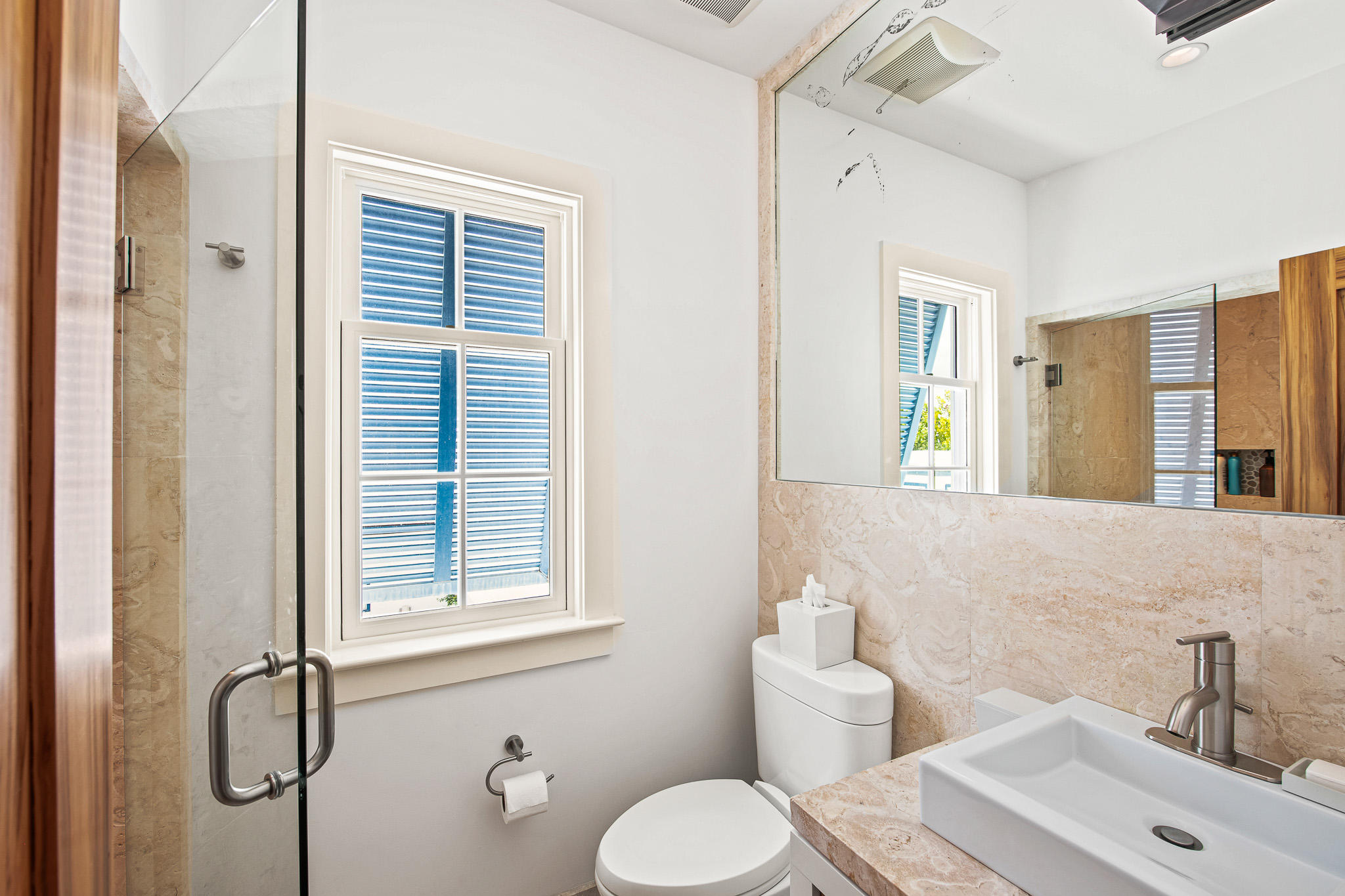 86 North Charles Street, Unit B9 Inlet Beach, FL 32461 - Photo 49 of 60 a bathroom with a toilet sink and mirror