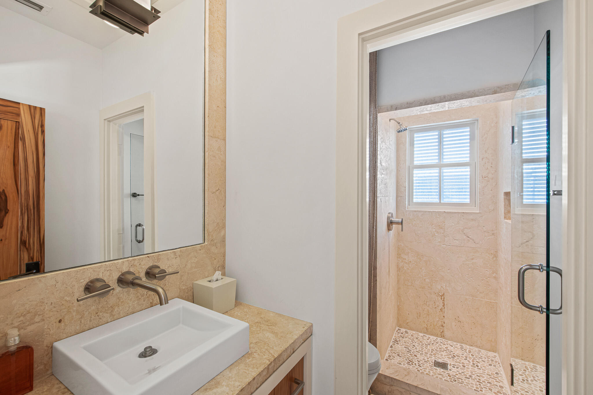 86 North Charles Street, Unit B9 Inlet Beach, FL 32461 - Photo 54 of 60 a bathroom with a sink a mirror and shower