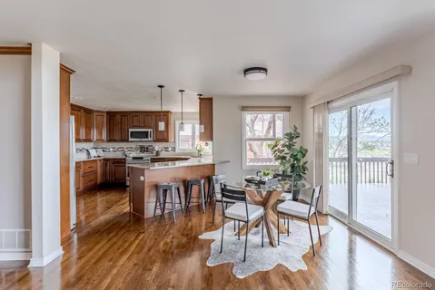 a kitchen with a table chairs refrigerator and cabinets