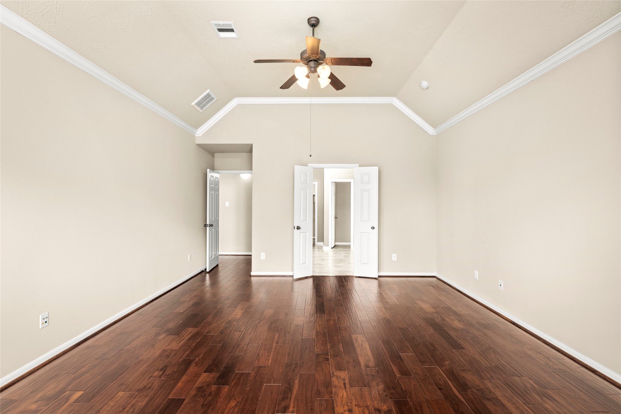 5307 Amber Sky Lane Rosharon, TX 77583 - Photo 23 of 50 The primary suite's wood flooring and double doors lead gracefully into the spa-inspired ensuite bath, true luxury, thoughtfully connected.