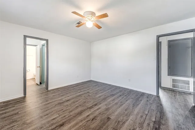 a bathroom with a toilet a sink a mirror a bathtub and vanity