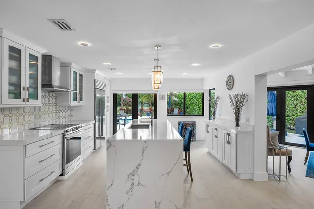 a kitchen with stainless steel appliances granite countertop a sink stove and a refrigerator