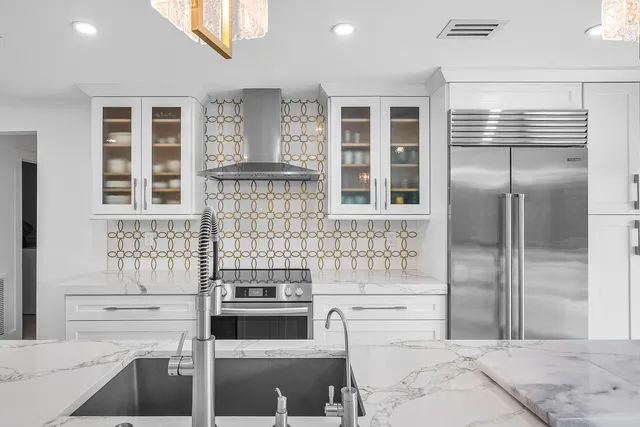 a kitchen with stainless steel appliances kitchen island granite countertop a kitchen island and chairs