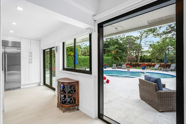a view of a dining room with furniture large windows and wooden floor