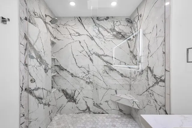 a bathroom with a double vanity sink toilet and a mirror