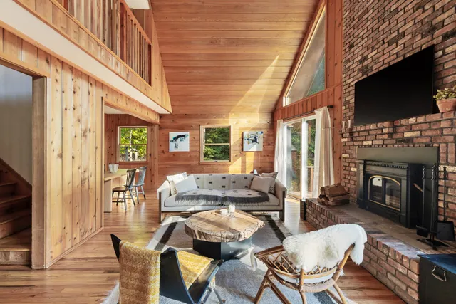 a living room with fireplace furniture and a flat screen tv