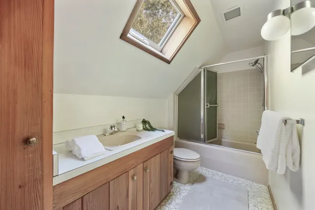 a spacious bathroom with a sink a toilet and a shower