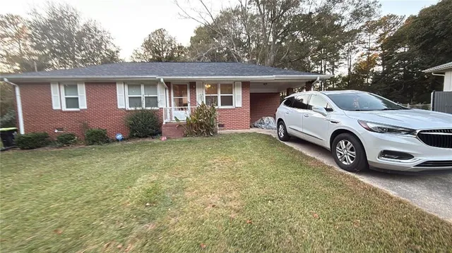 a front view of a house with a garden and plants