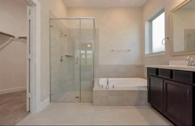 a bathroom with a bathtub and a shower