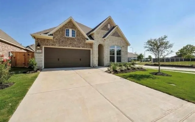 a front view of a house with yard