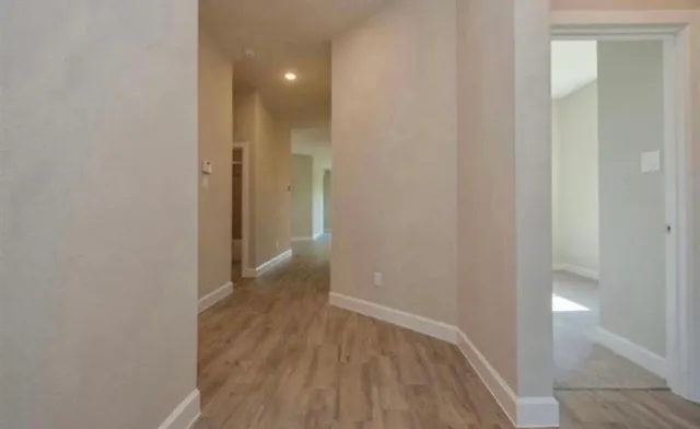 a view of a room with wooden floor