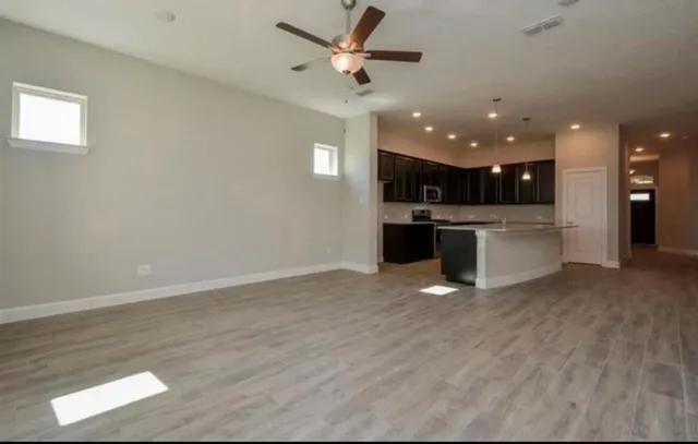 a view of a kitchen with a sink and microwave
