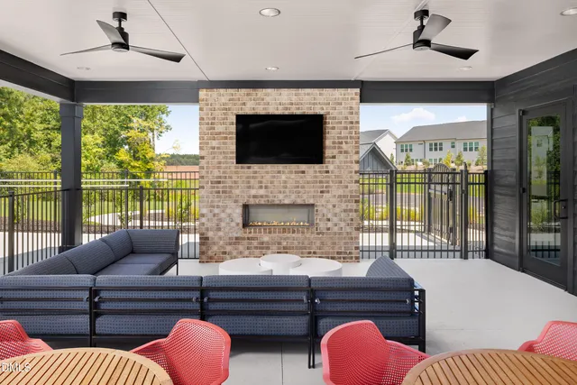 a view of a patio with couches table and chairs and potted plants