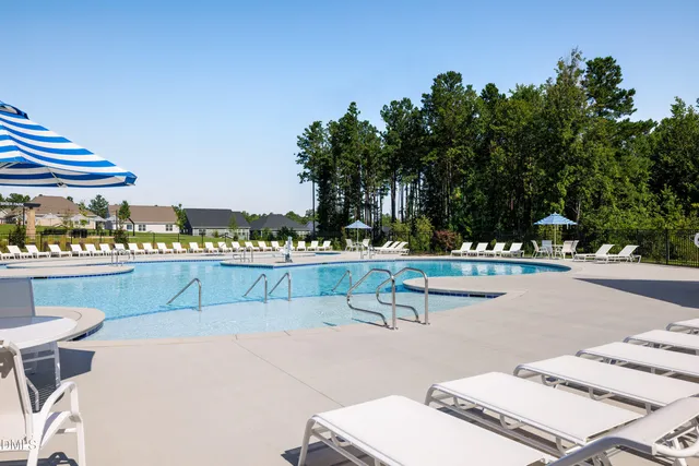 a swimming pool with some trees in the background