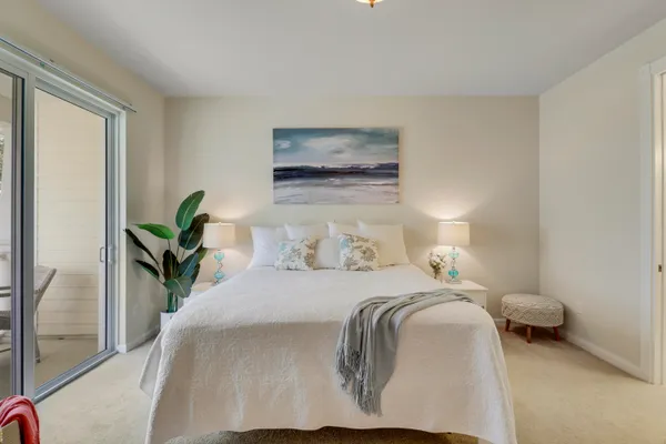 a bedroom with a bed and a painting on the wall