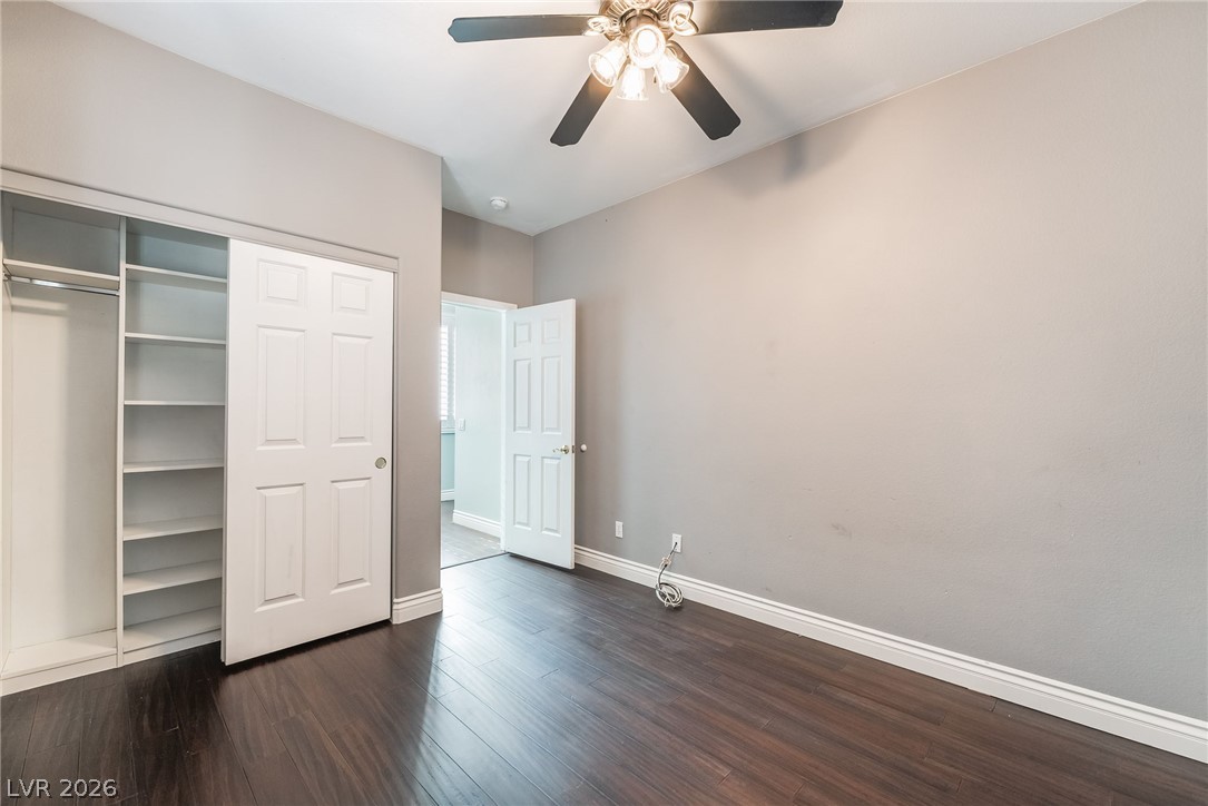 261 Timber Hollow Street Henderson, NV 89012 - Photo 25 of 51 Rich hardwood floors complement this peaceful bedroom with built-in closet shelving.