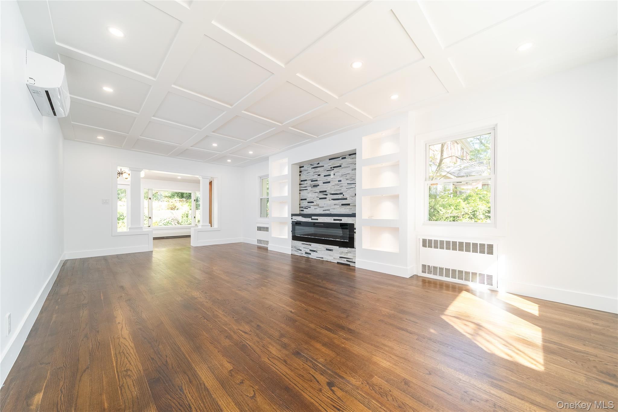 86-32 Midland Parkway Queens, NY 11432 - Photo 11 of 26 a view of an empty room with a window and wooden floor