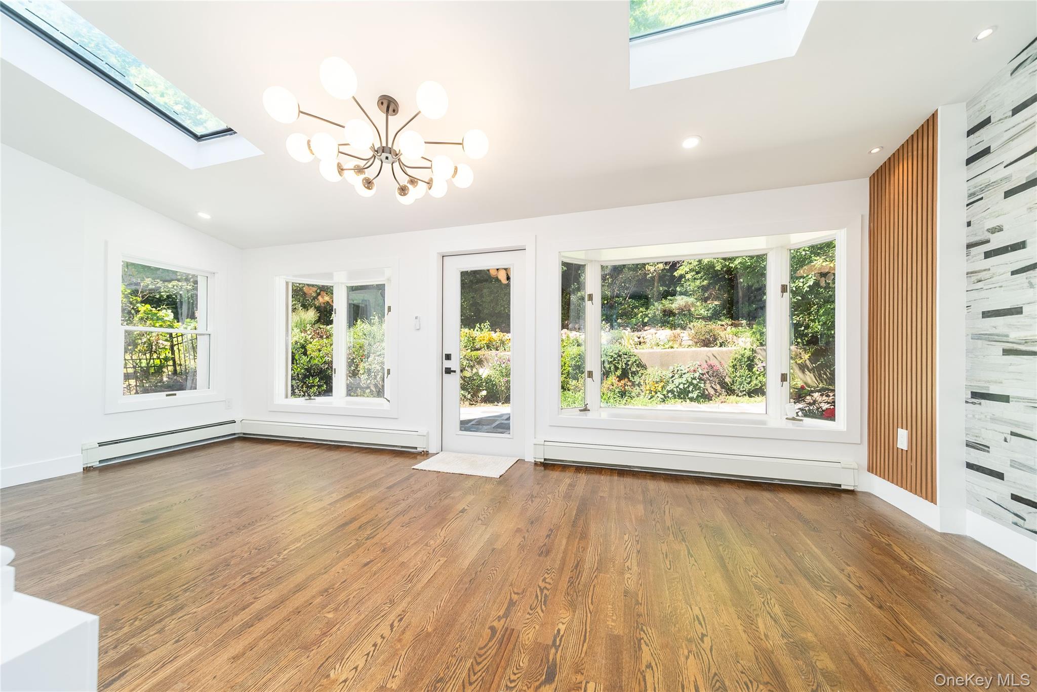 86-32 Midland Parkway Queens, NY 11432 - Photo 12 of 26 a view of an empty room with wooden floor and a window