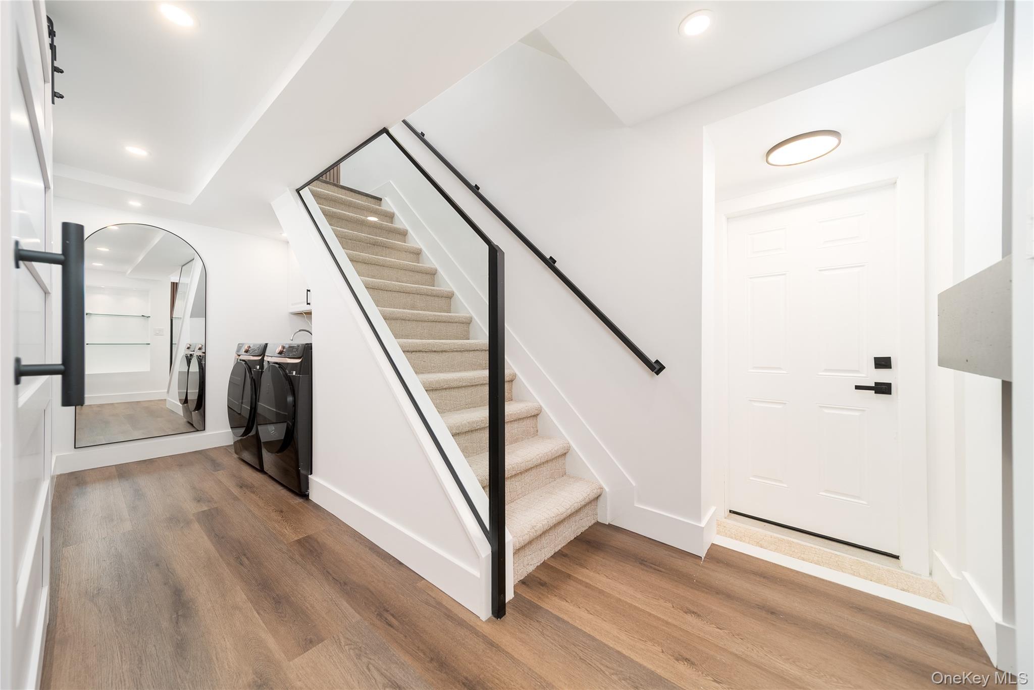 86-32 Midland Parkway Queens, NY 11432 - Photo 19 of 26 a view of a hallway with wooden floor and staircase