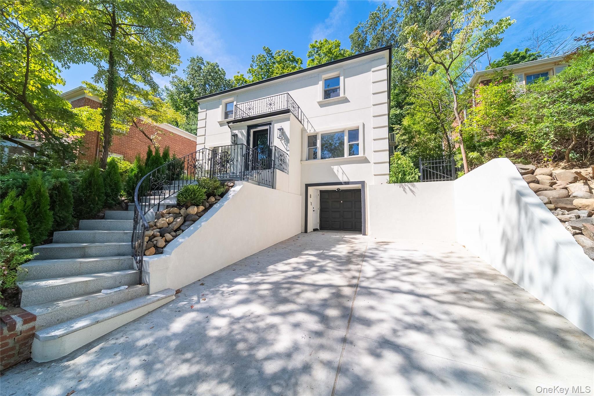 86-32 Midland Parkway Queens, NY 11432 - Photo 2 of 26 a view of a white house with a yard and plants