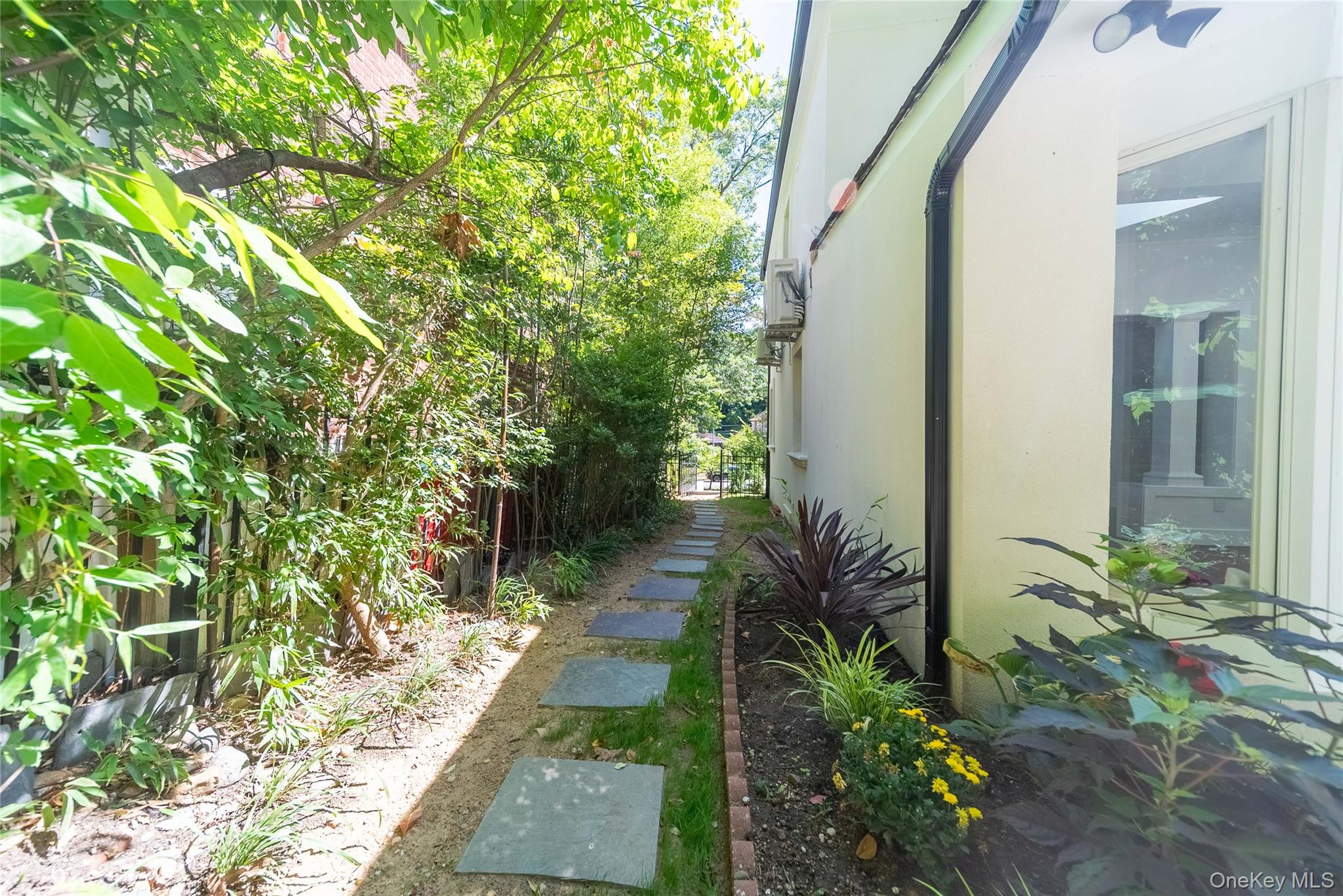 86-32 Midland Parkway Queens, NY 11432 - Photo 24 of 26 a backyard of a house with outdoor seating and green space