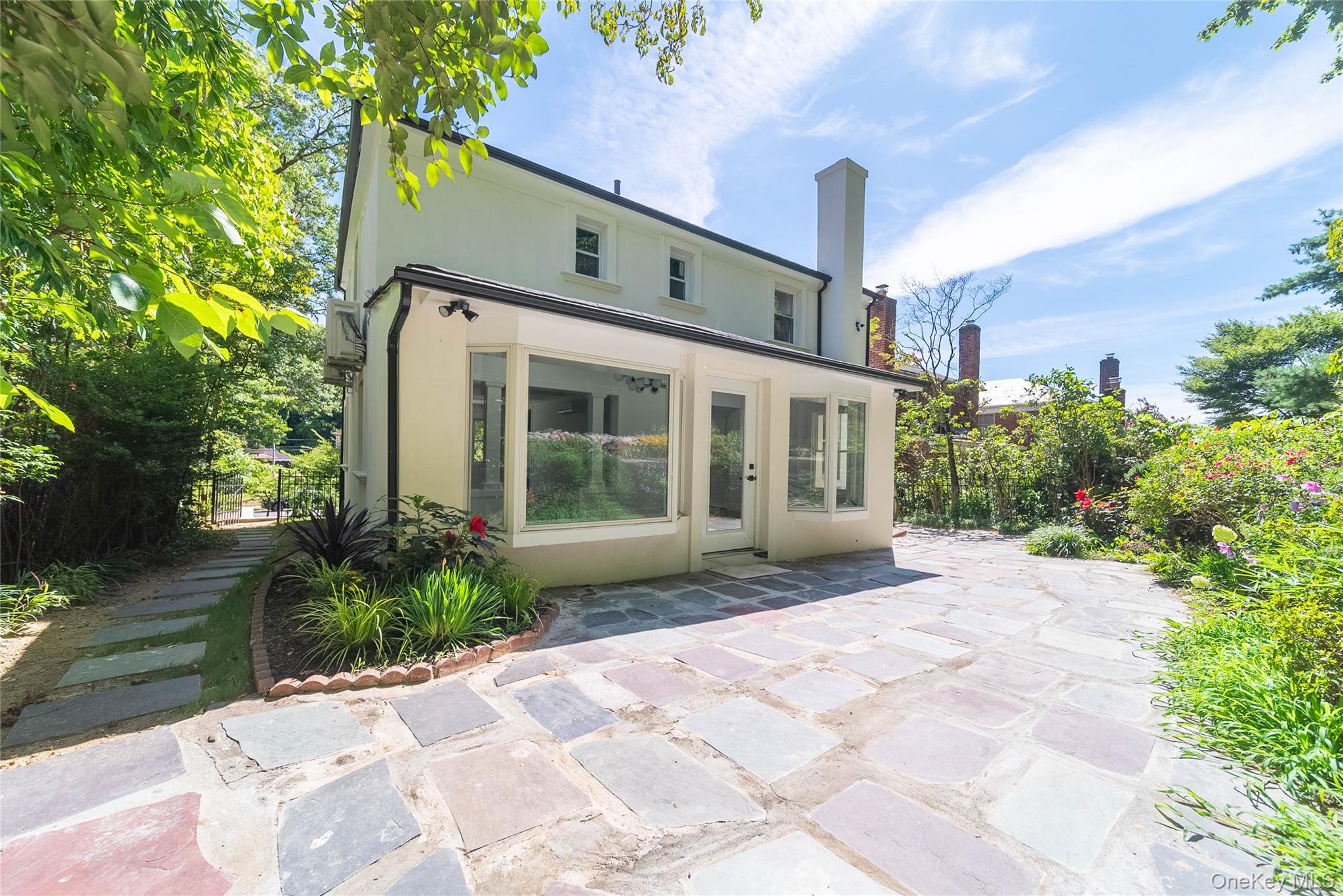 86-32 Midland Parkway Queens, NY 11432 - Photo 25 of 26 a view of a house with a yard and plants