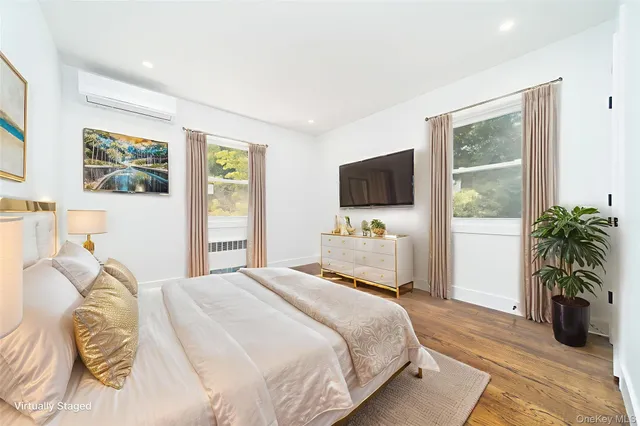 a bedroom with a bed and flat screen tv