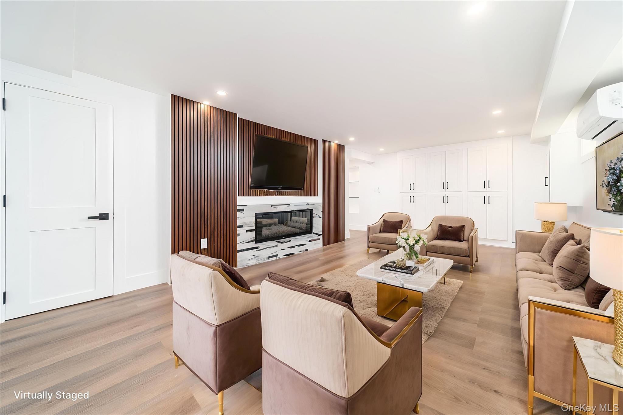 86-32 Midland Parkway Queens, NY 11432 - Photo 8 of 26 a living room with furniture a flat screen tv and a refrigerator