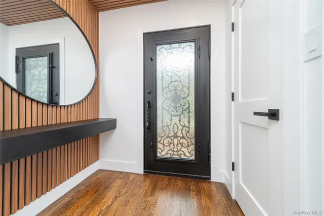a view of a hallway with wooden floor and entryway
