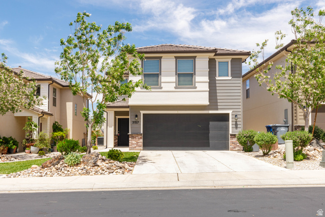 3157 Deseret Drive St. George, UT 84790 - Photo 1 of 24 Contemporary two-story residence featuring a two-car garage, stone façade accents, and a covered entryway