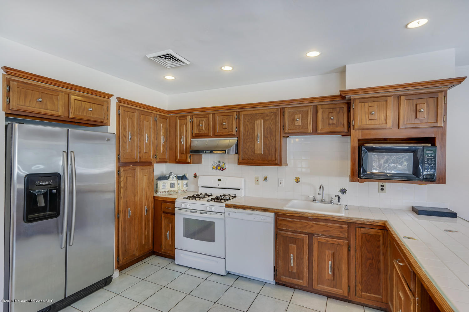 351 Iron Ore Road Manalapan, NJ 07726 - Photo 11 of 20 a kitchen with stainless steel appliances granite countertop a refrigerator sink and stove