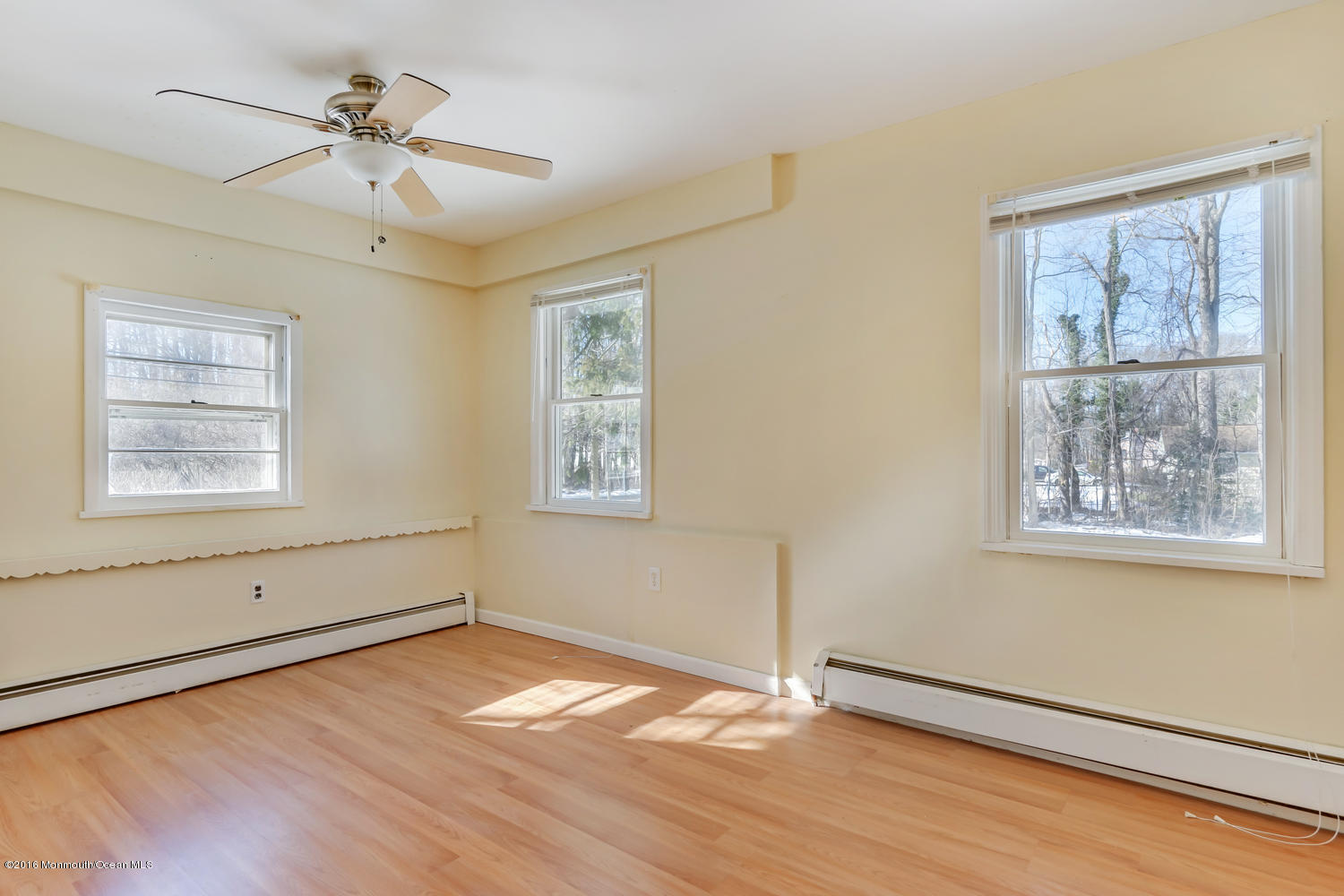 351 Iron Ore Road Manalapan, NJ 07726 - Photo 7 of 20 a view of an empty room with a window and wooden floor