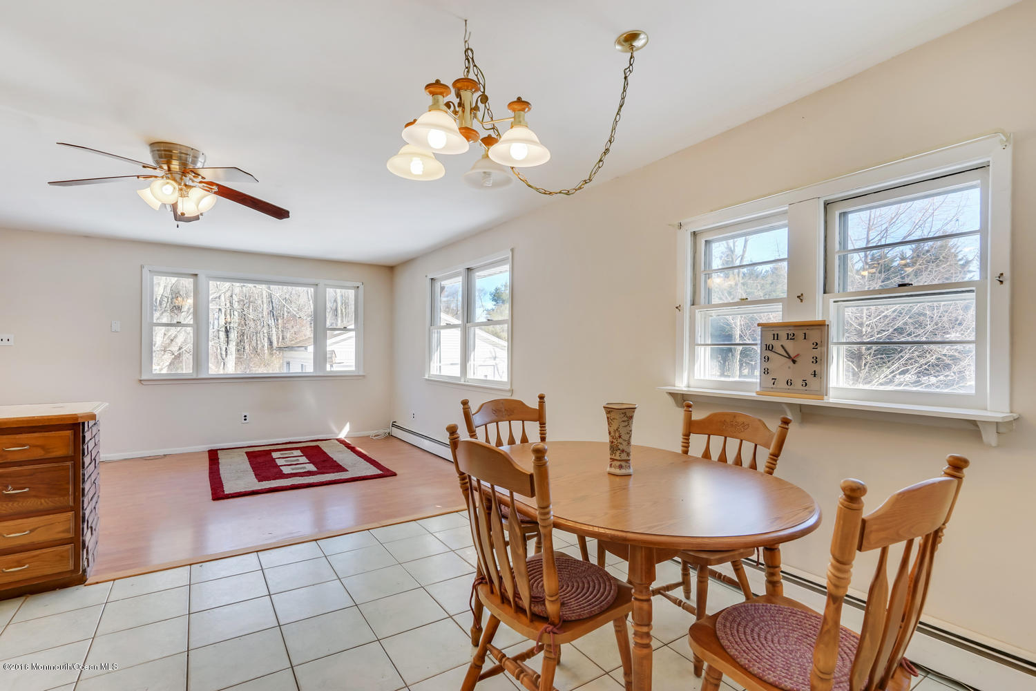 351 Iron Ore Road Manalapan, NJ 07726 - Photo 9 of 20 a view of a dining room with furniture and chandelier