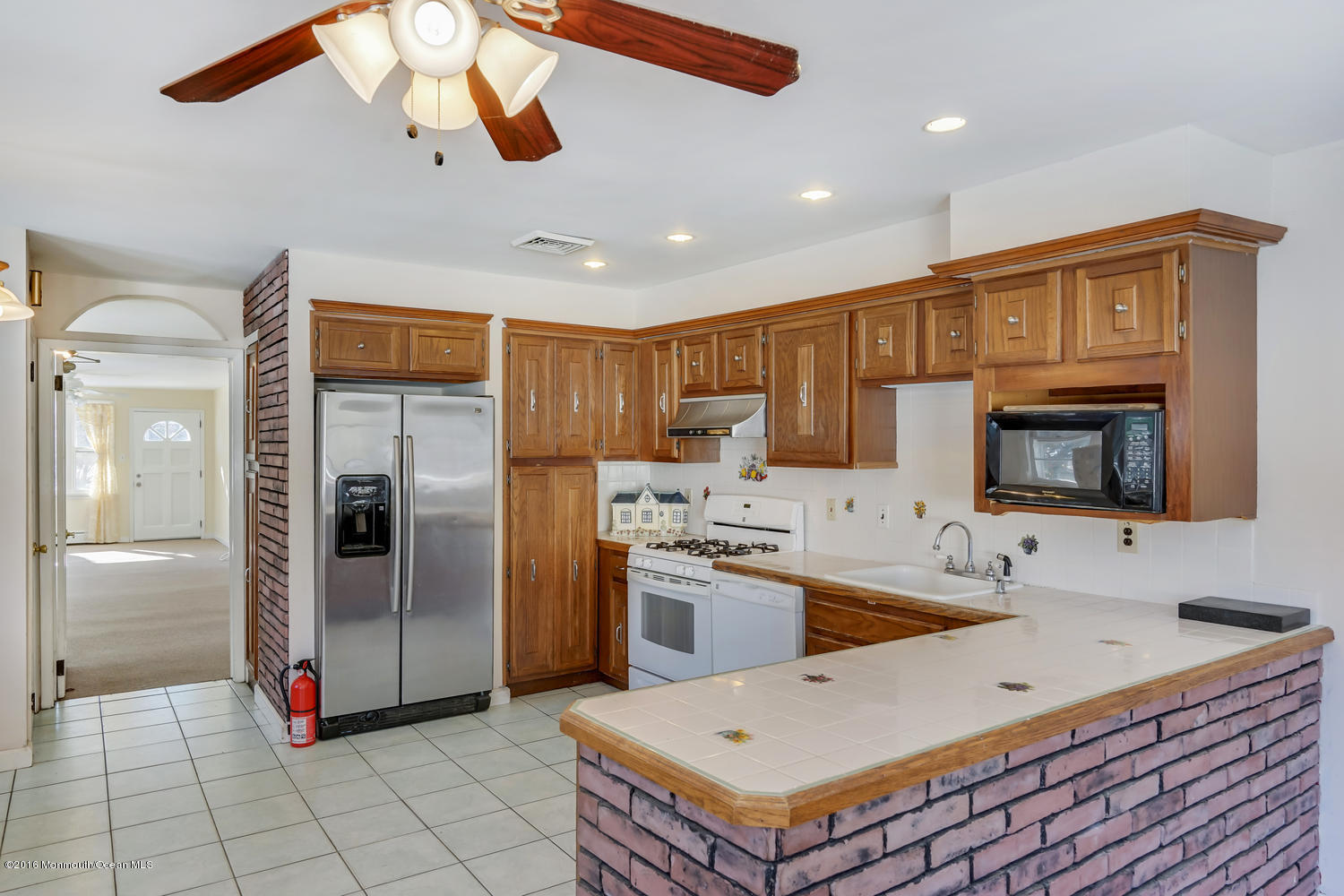 351 Iron Ore Road Manalapan, NJ 07726 - Photo 10 of 20 a kitchen with stainless steel appliances granite countertop a sink a stove and a refrigerator
