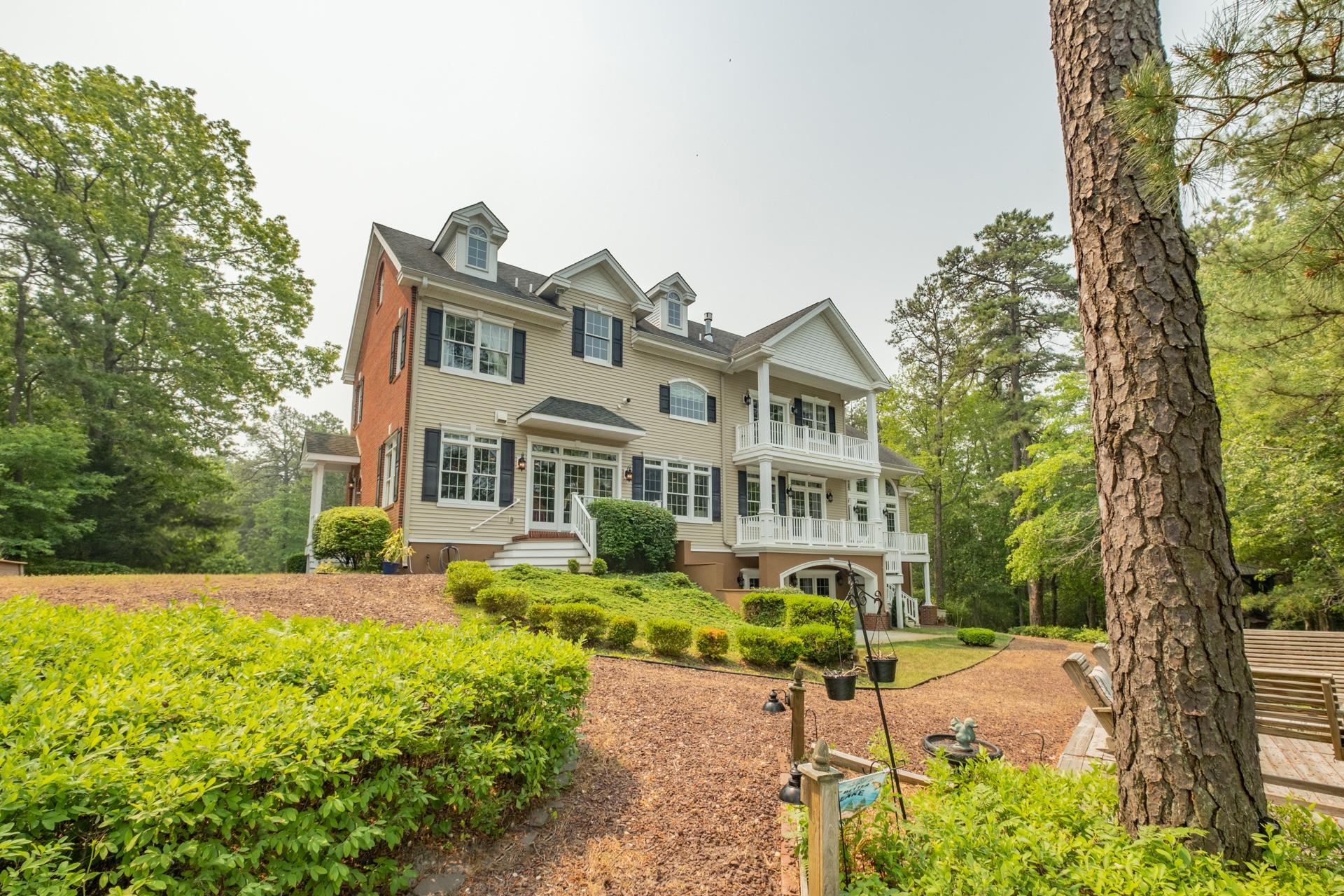 286 Riverside Drive Port Republic, NJ 08241 - Photo 3 of 50 a front view of a house with a garden and a tree