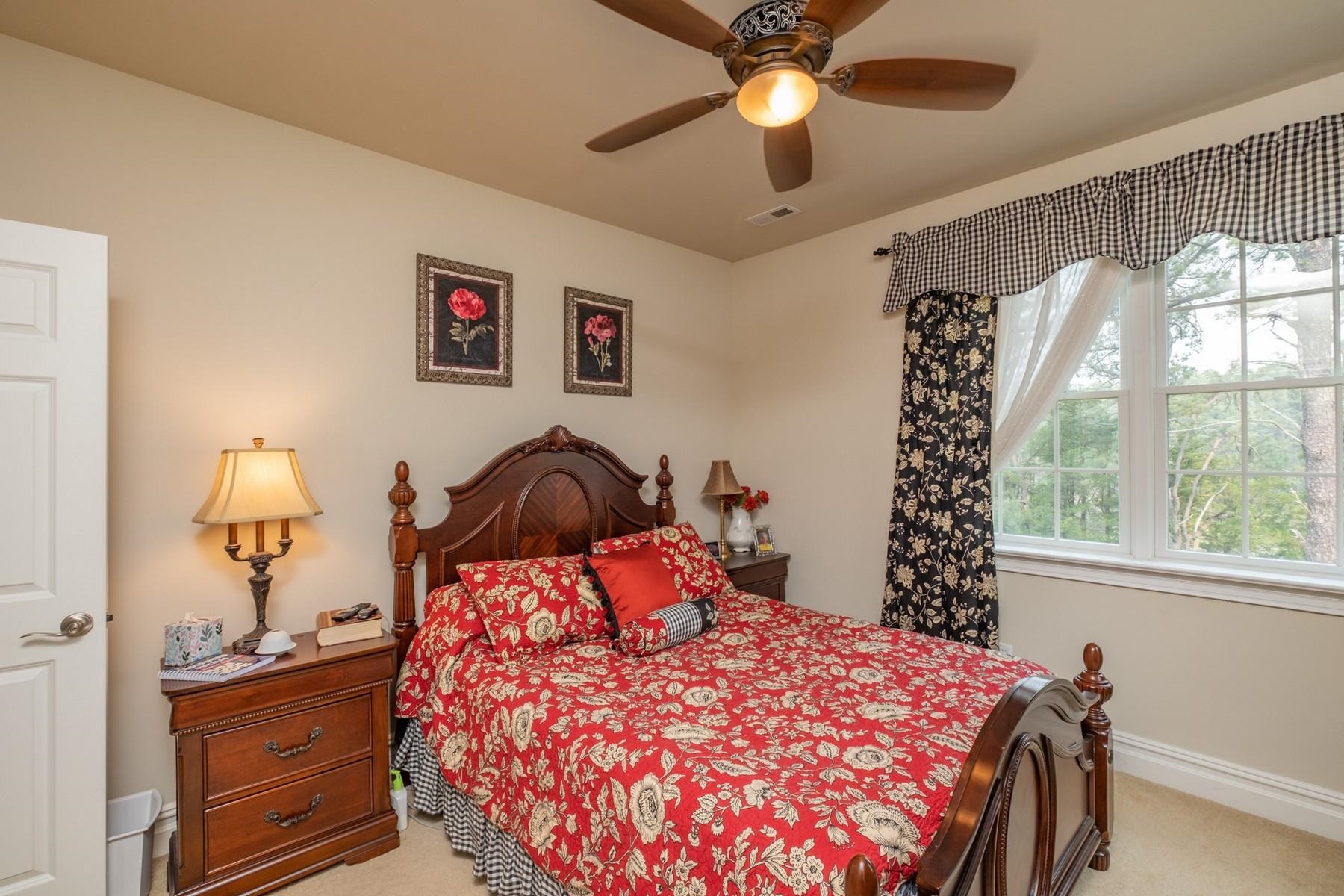 286 Riverside Drive Port Republic, NJ 08241 - Photo 33 of 50 a bedroom with a bed and a chandelier