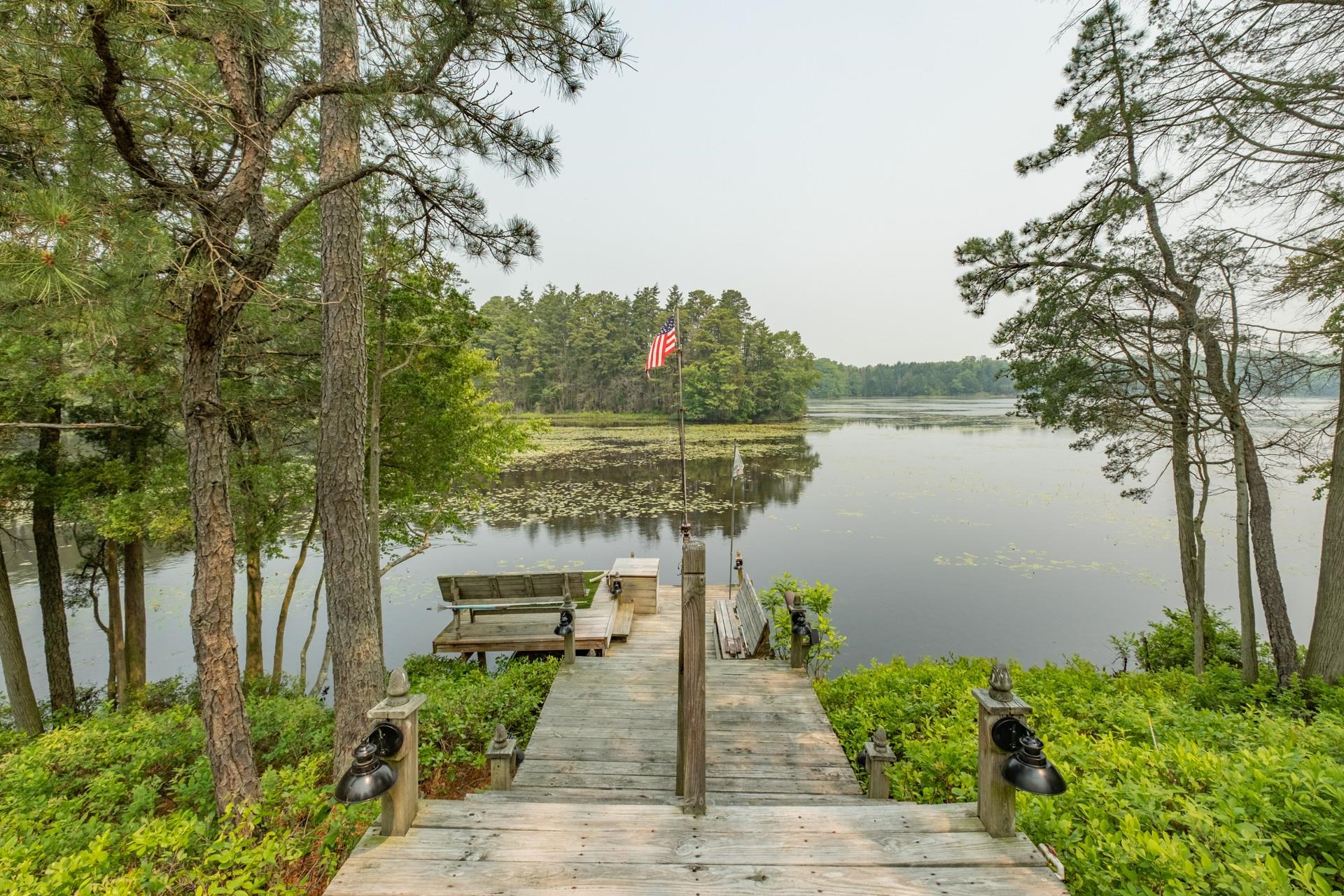 286 Riverside Drive Port Republic, NJ 08241 - Photo 5 of 50 a front view of a house with a yard and potted plants